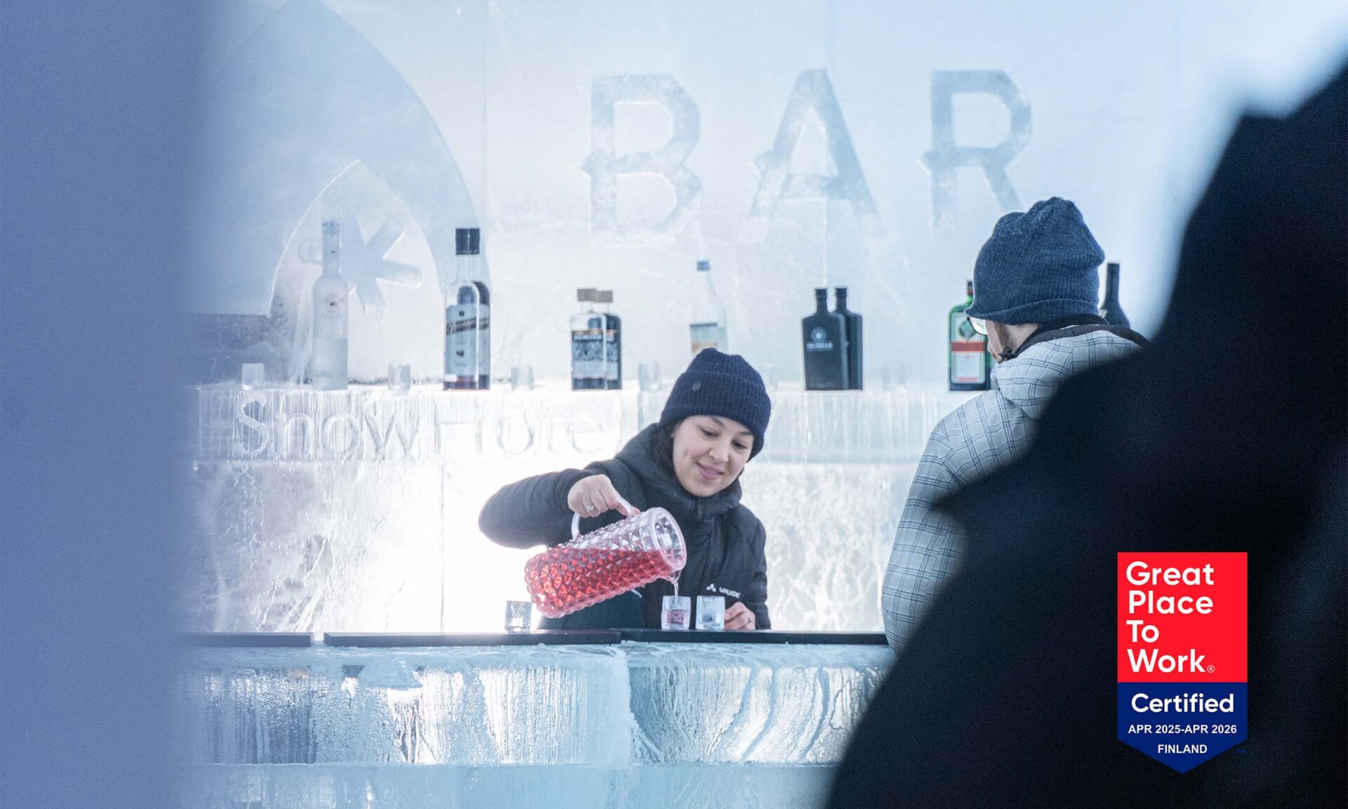 Bartender pouring drink to an ice glass in the Ice Bar