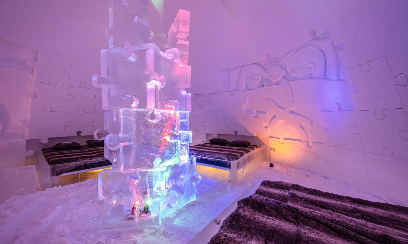 Ice sculpture illuminated with colourful lights inside Arctic SnowHotel.
