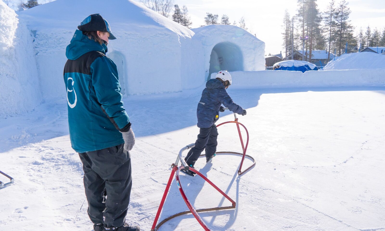 Child skating with a guide at Snowman World.