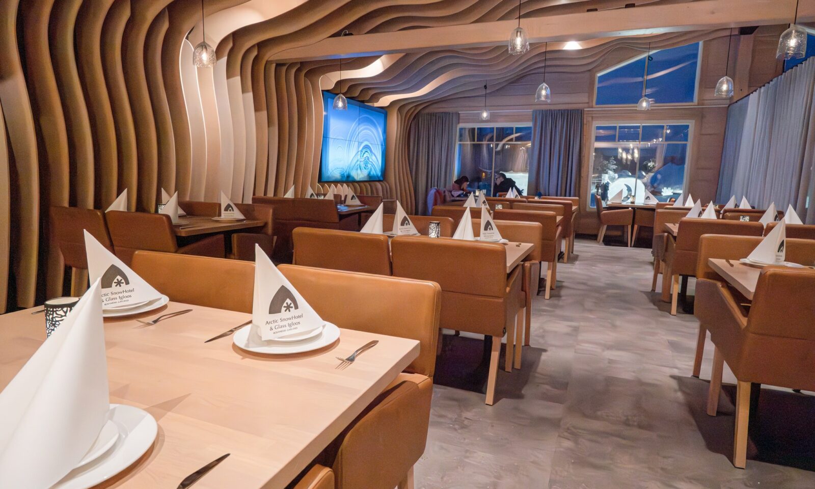 ining area inside the Log Restaurant at Arctic SnowHotel & Glass Igloos.