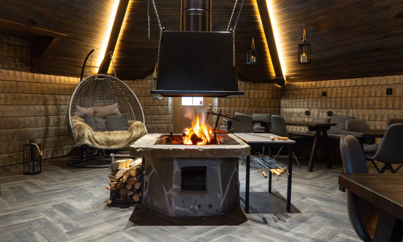 Small Kota private dining space with a central fireplace at Arctic SnowHotel & Glass Igloos.