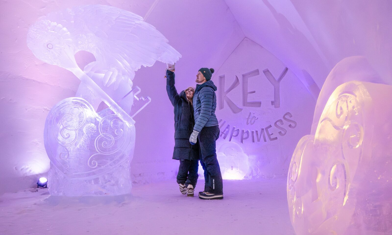 Visitors exploring snow and ice art inside Arctic SnowHotel.